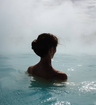 Woman relaxing in a natural hot spring